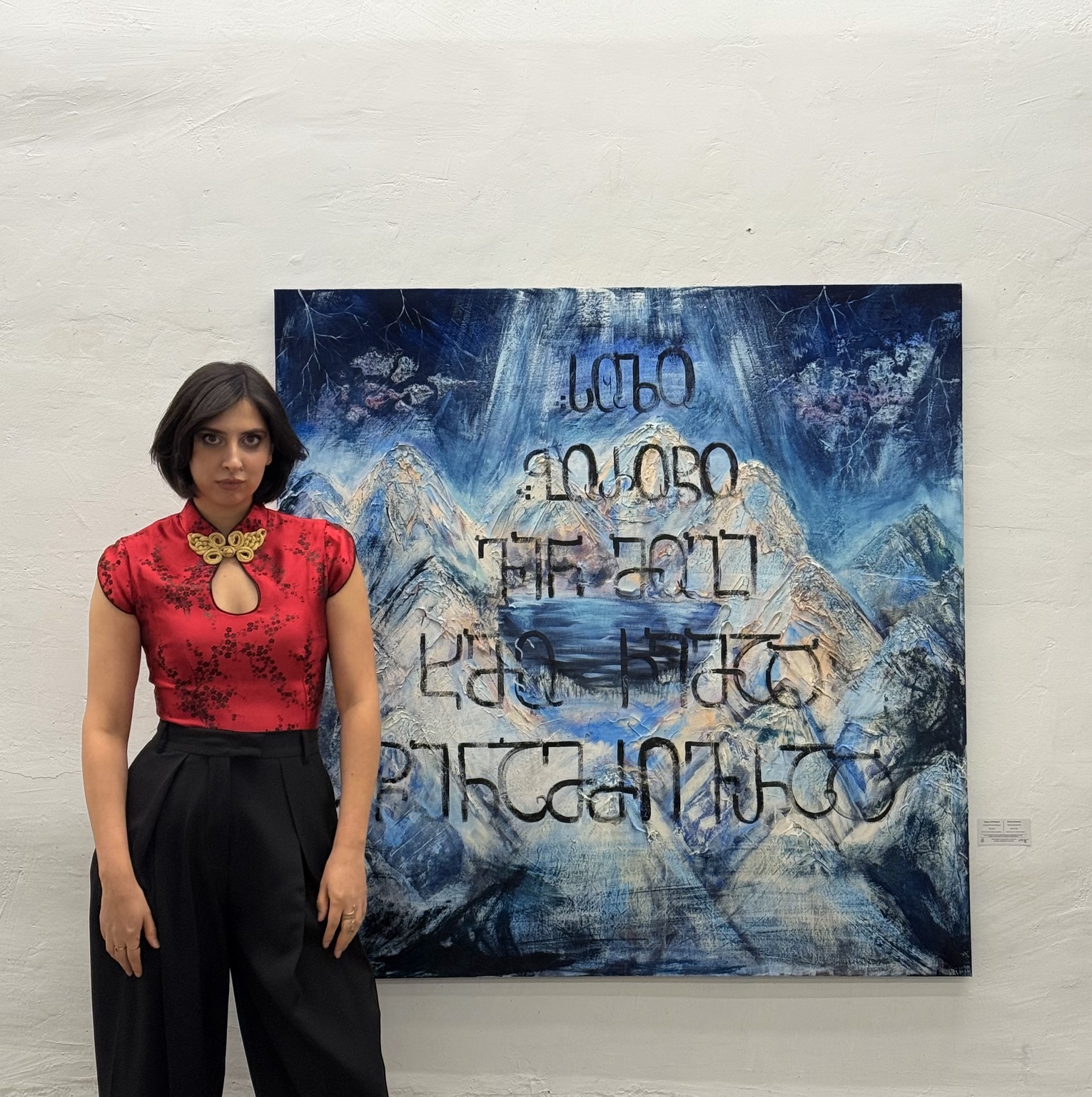 Medea Kirimeli with her painting at an exhibition